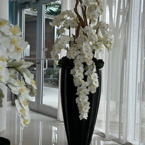 San Jose Vase in glossy black with hanging yellow orchids